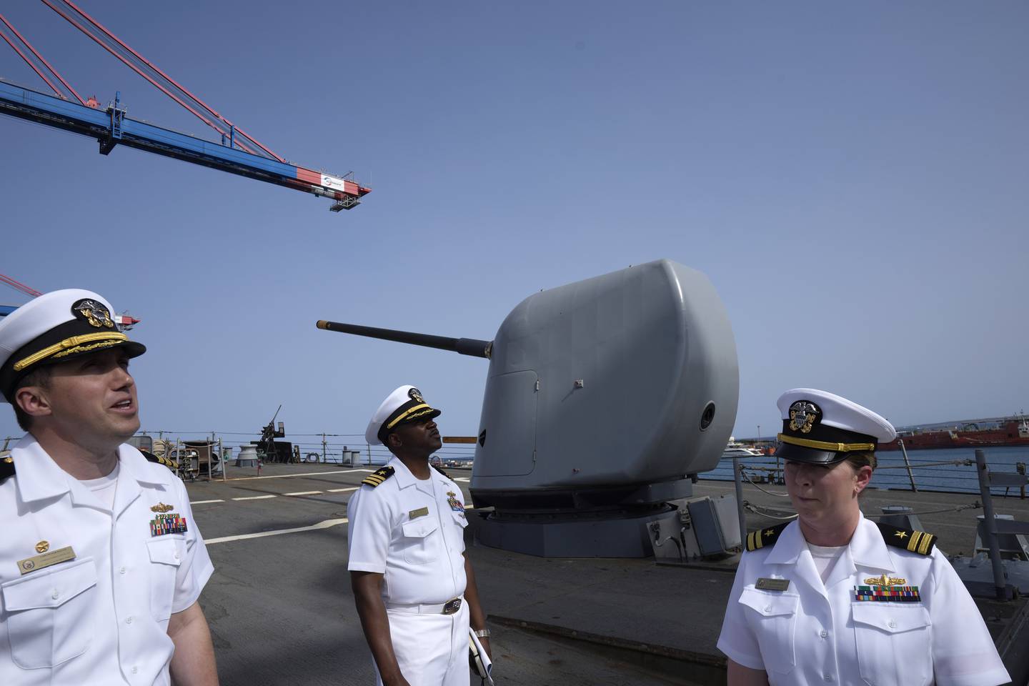 Cmdr. Captain Peter Flynn, left, Cmdr. Executive Officer Tyrchra Bowman, center, and weapons officer Lt. Lindsey Boyle stand on the missile destroyer USS Arleigh Burke, docked in the port in southern city of Limassol, Cyprus, Wednesday, May 17, 2023.